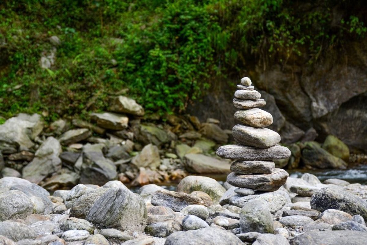 Rocks stacked in a cairn by the water