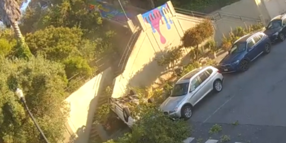 NextImg:Viral video shows car flying onto San Francisco street, occupants flee crash site: 'It looked like a scene out of Dukes of Hazard'