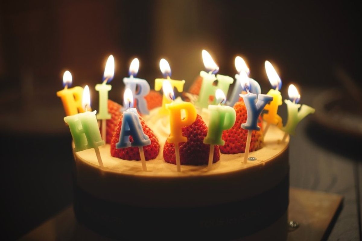 birthday cake with candles that say happy birthday