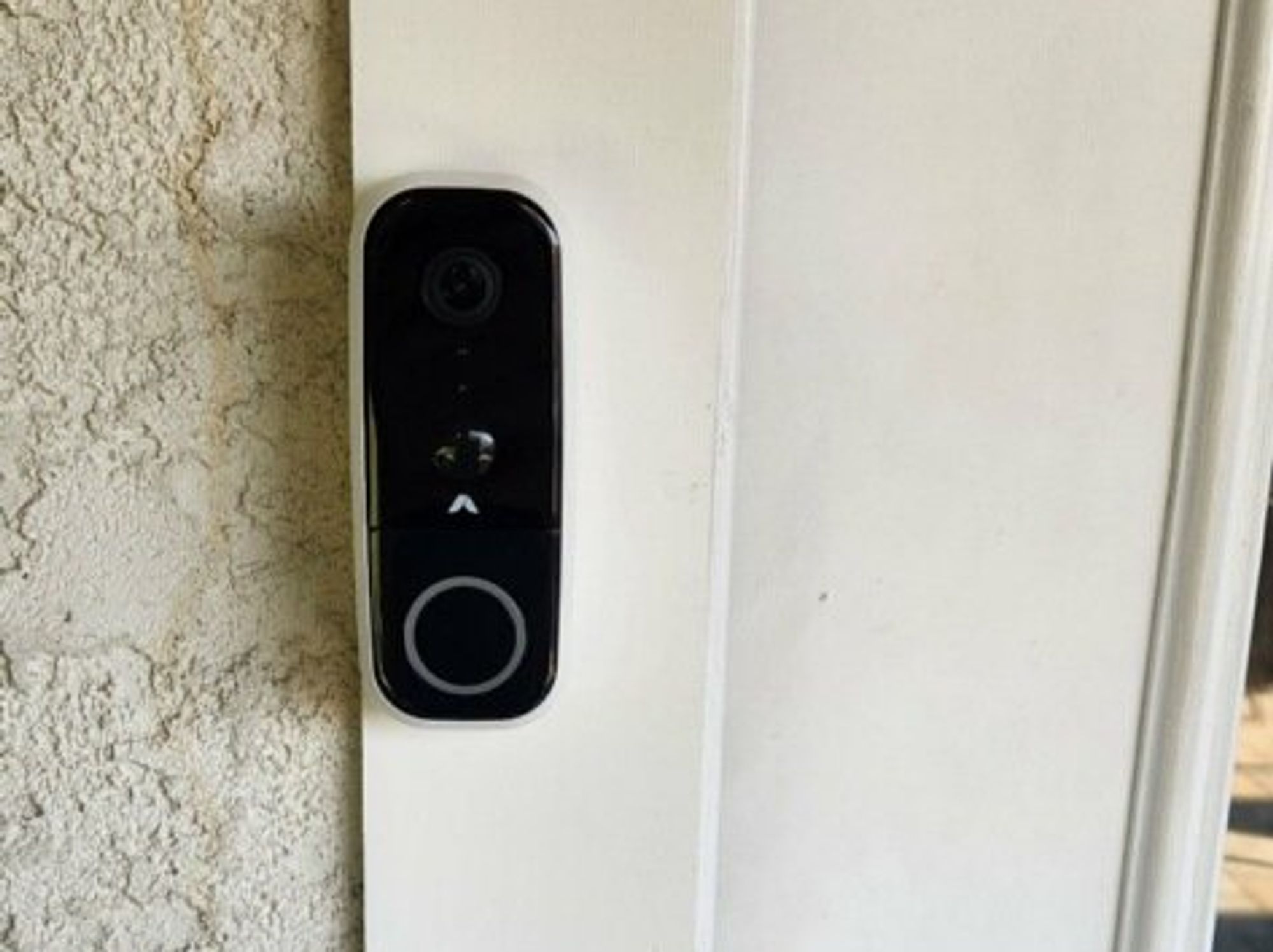 a photo of Abode Wireless Video Doorbell installed on a door