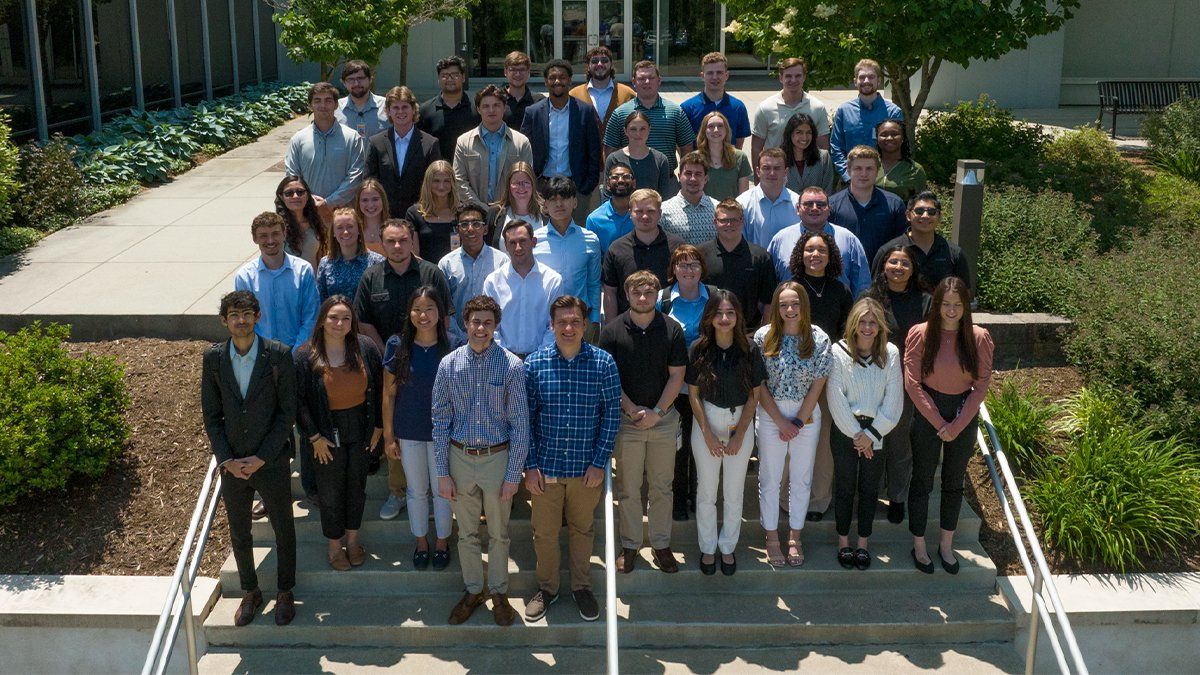 Interns stand outside the company headquarters on the stairs in Green Hills, Pennsylvania. 