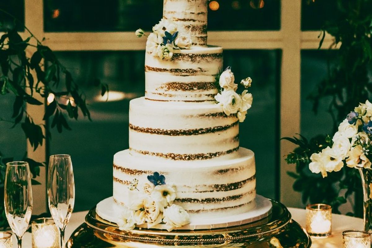 a four-tier wedding cake in soft light.