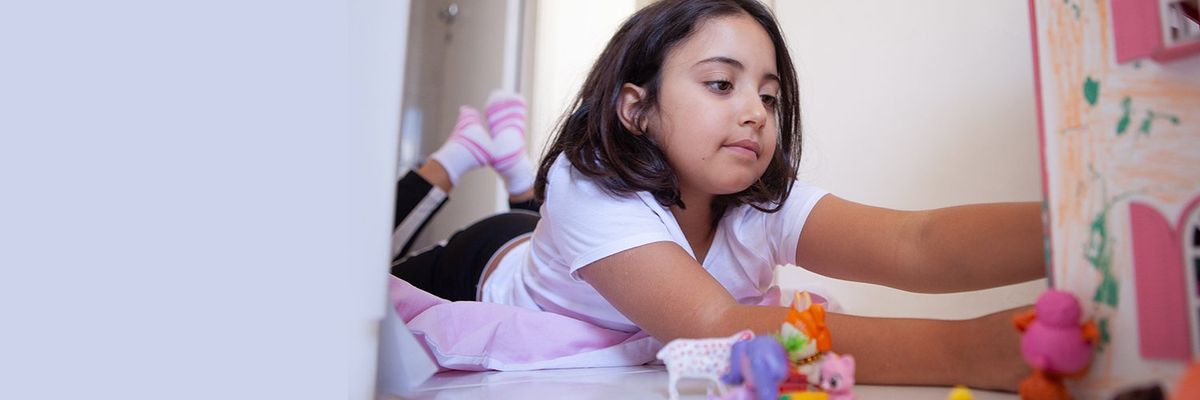 a girl playing with her dollhouse