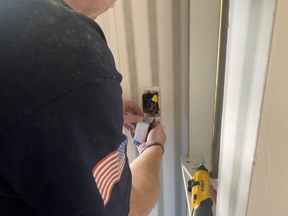 An electrician removing an old switch