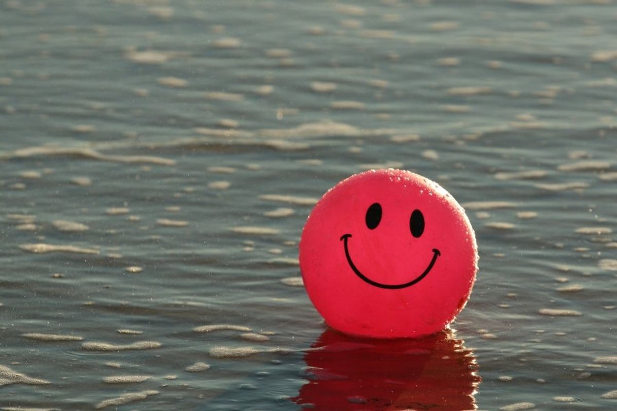 smiley face ball floating in the water