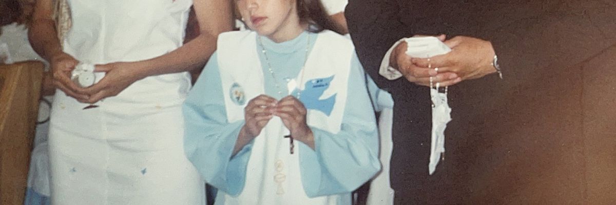 an image of a girl in a first communion ceremony