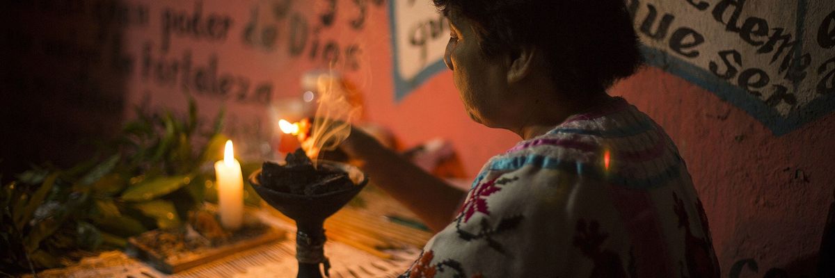 Image of a curandera performing a cleansing ritual in Huautla de Jim\u00e9nez
