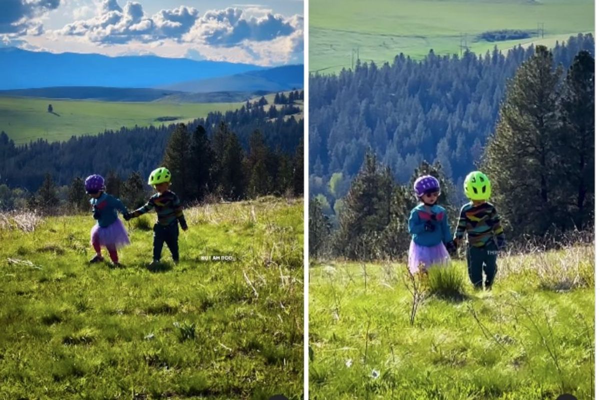 two preschoolers walking in the mountains holding hands