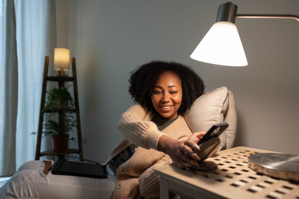 Black-woman-in-reading-nook-turning-phone-off