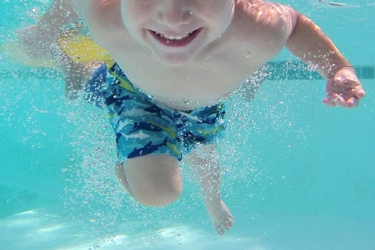 child swimming in a pool