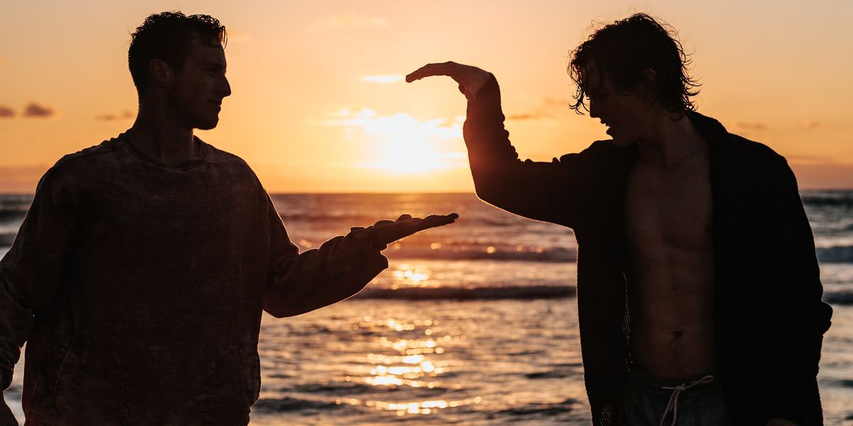 Two men on the beach giving each other high five