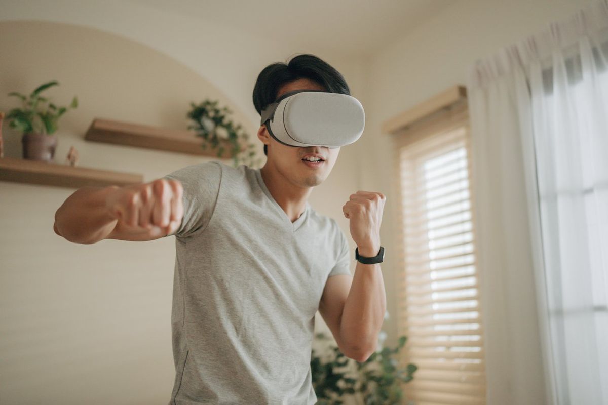 A man working out with VR Headset on and wearing a fitness tracker