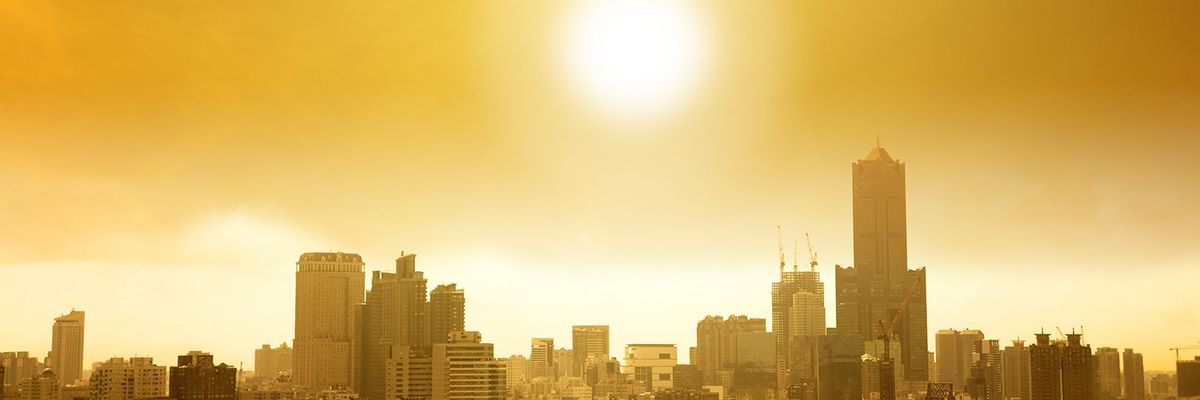 image of the sun over a city skyline