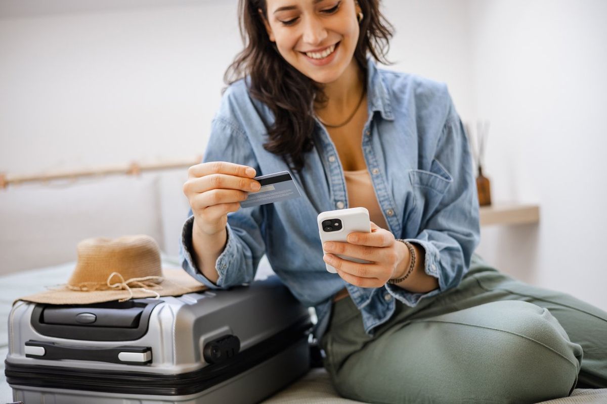 a woman making an online payment with her credit card and smartphone