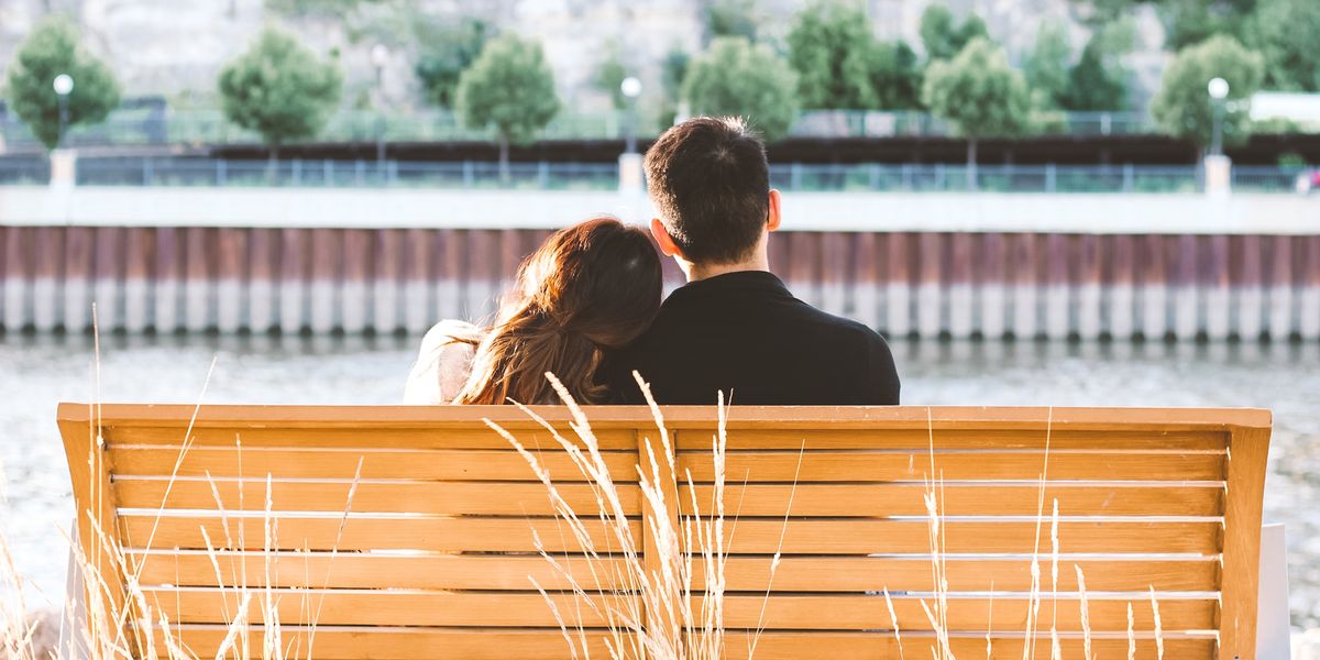Couple sitting together on bench