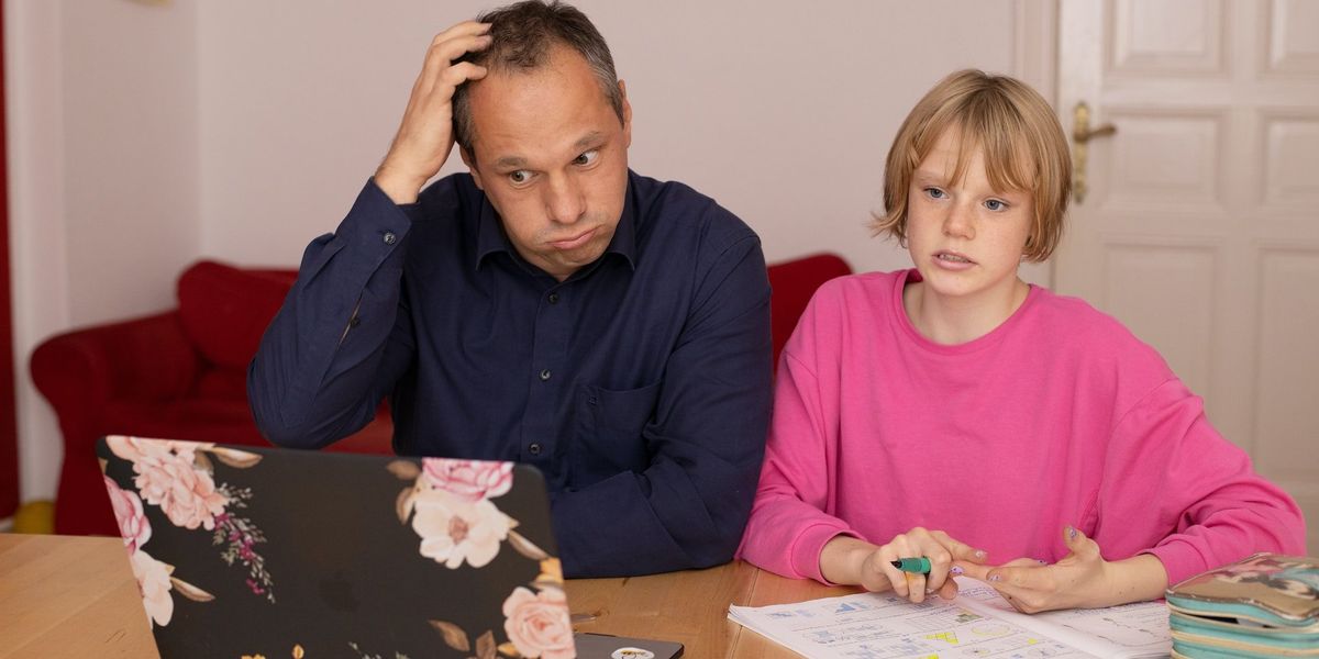 Perplexed father with his daughter looking at her computer