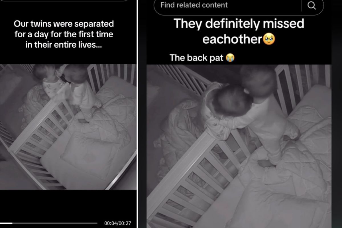 twin babies hugging over the side of their cribs