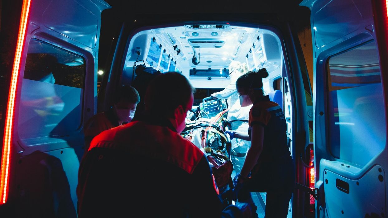 Paramedics load a patient into an ambulance