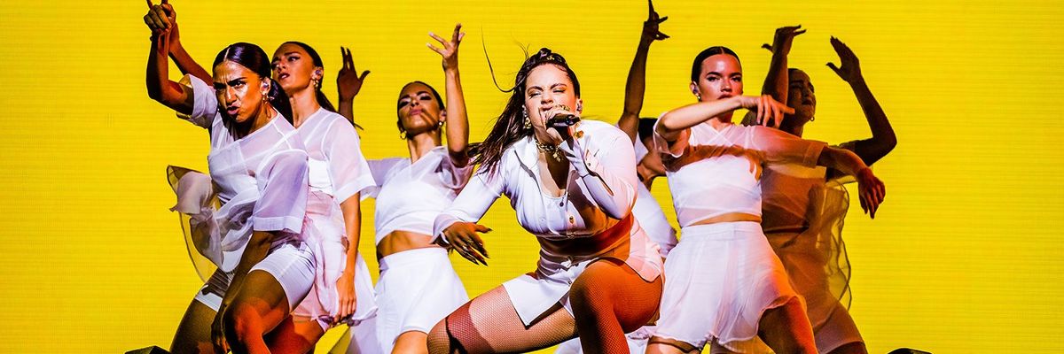 Spanish singer Rosalia surrounded by brown skinned dancers