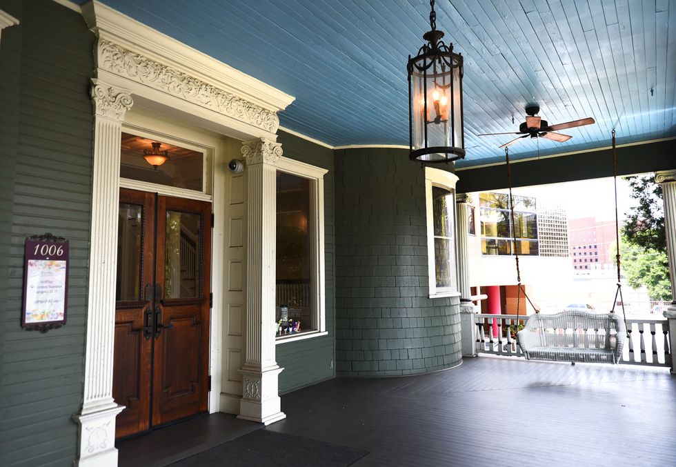 An outdoor porch featuring a blue painted ceiling. A popular trend in Southern culture.