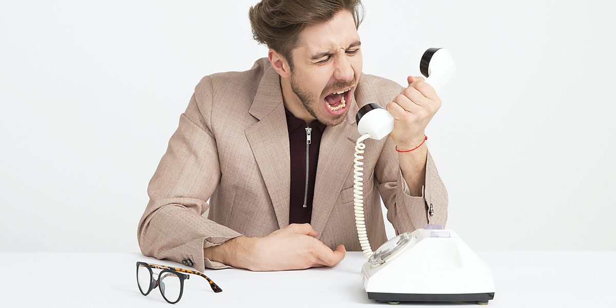 man holding telephone screaming