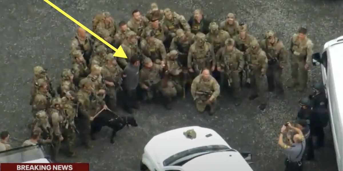Leftists cry foul over 'photo op' of law enforcement around captured illegal alien fugitive — a convicted killer. But state cop shoots them all down.