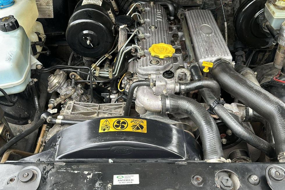 1995 Land Rover Defender 90 engine bay showing 300TDi 2.5-liter turbodiesel inline-four engine