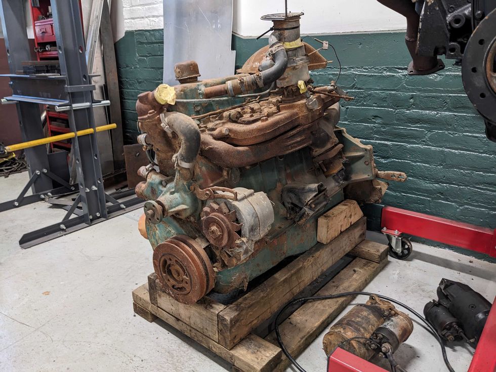 A 292-cu.in. Chevrolet High-Torque six-cylinder sits on a pallet in a workshop.