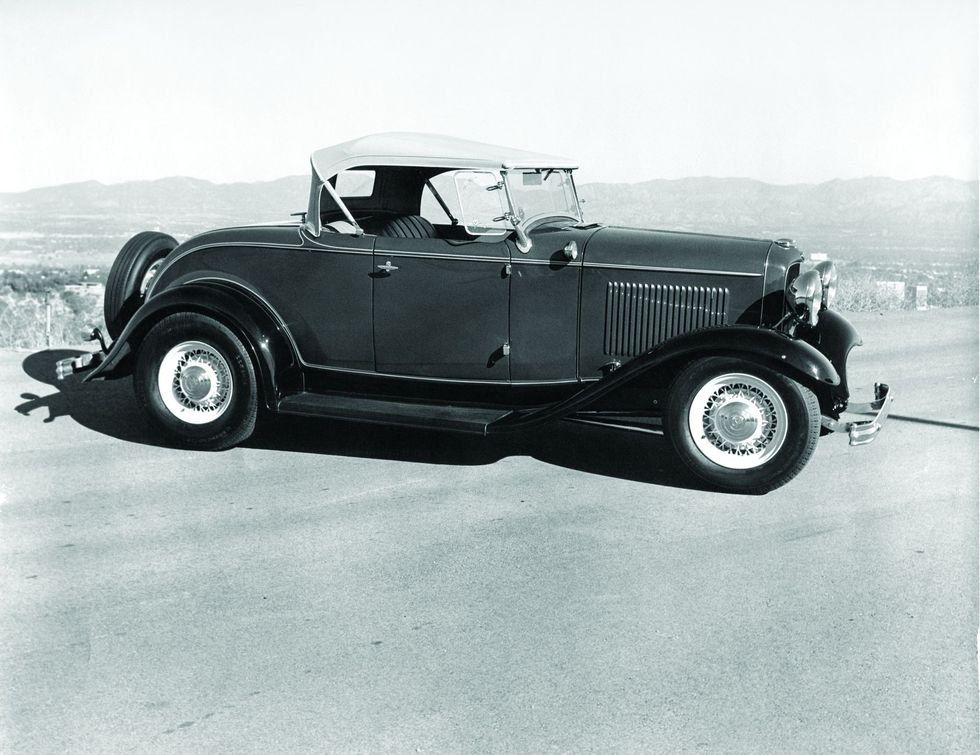 B&W image of a Ford roadster parked in a profile position.