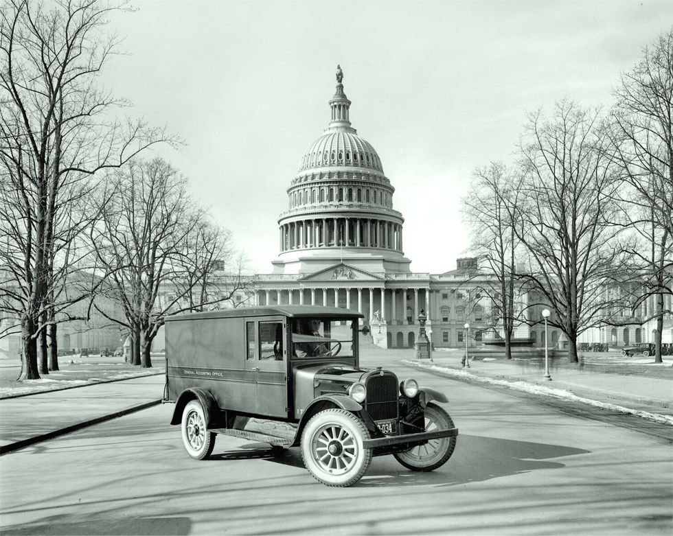 B&W period image of a 1925 Graham Express truck parked in a front 3/4 position in front of the Capitol.