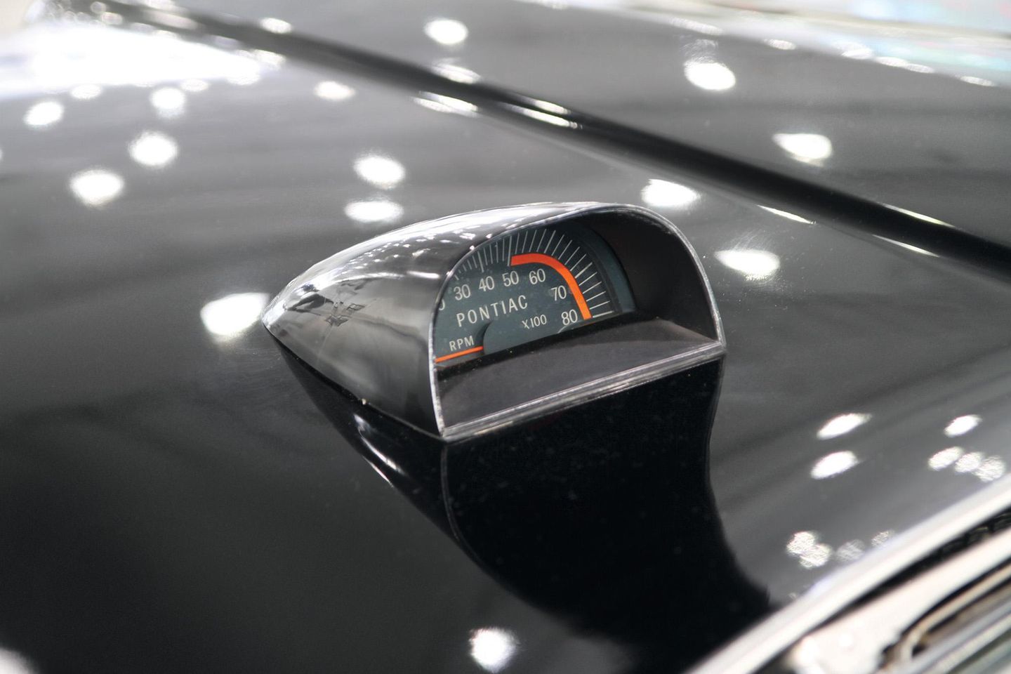 Color closeup of a hood tachometer on a 1967 Pontiac Catalina 2+2.