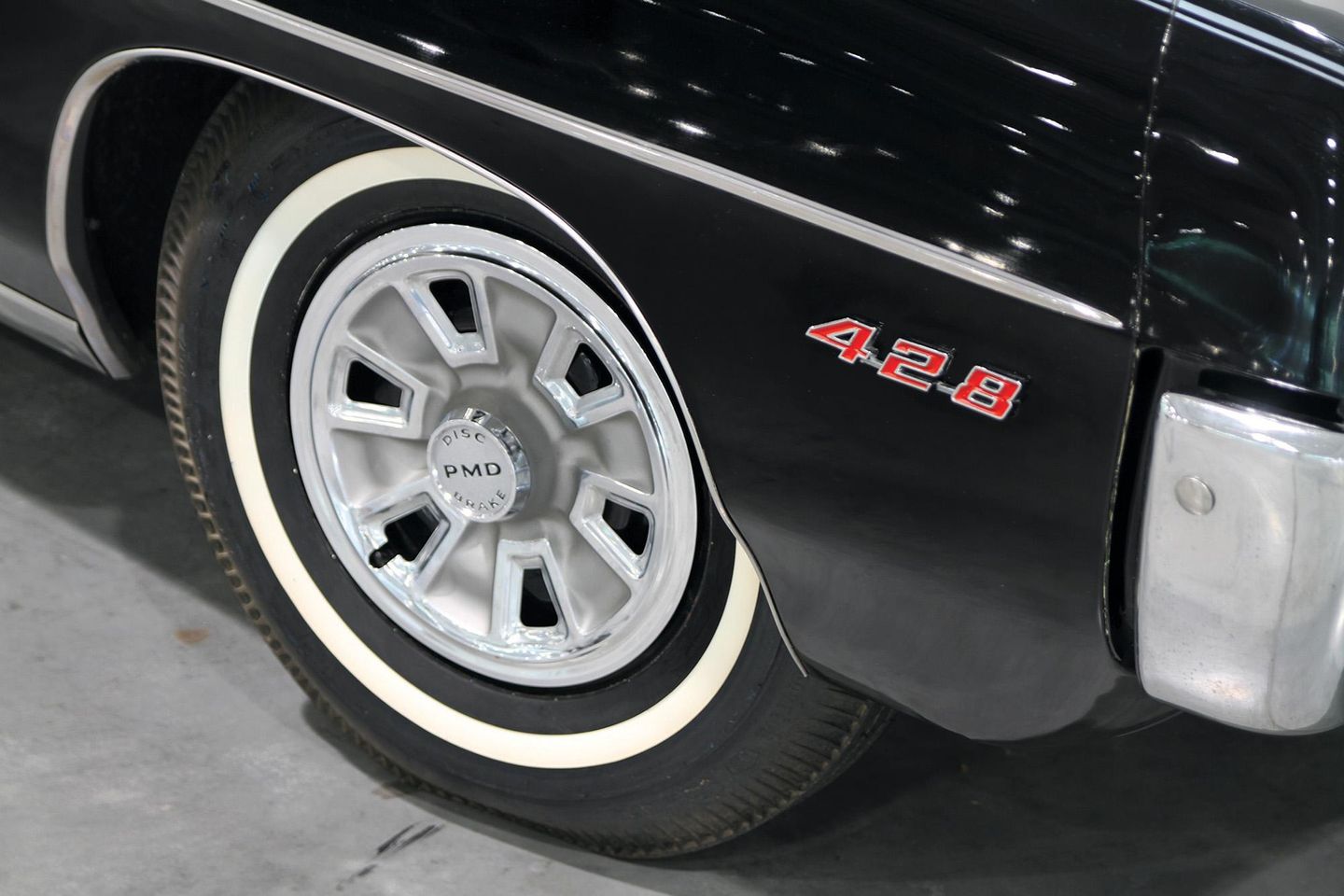 Color closeup of a wheel and tire on a 1967 Pontiac Catalina 2+2.