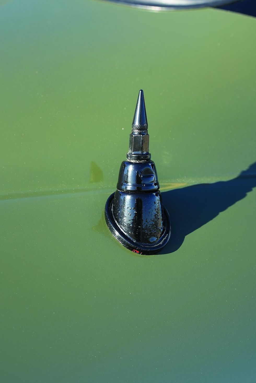 Color closeup of the antenna on a customized 1965 Volkswagen Karmann Ghia.