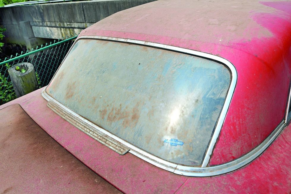 Color closeup of the back glass on a 1962 Chevrolet Impala barn find.