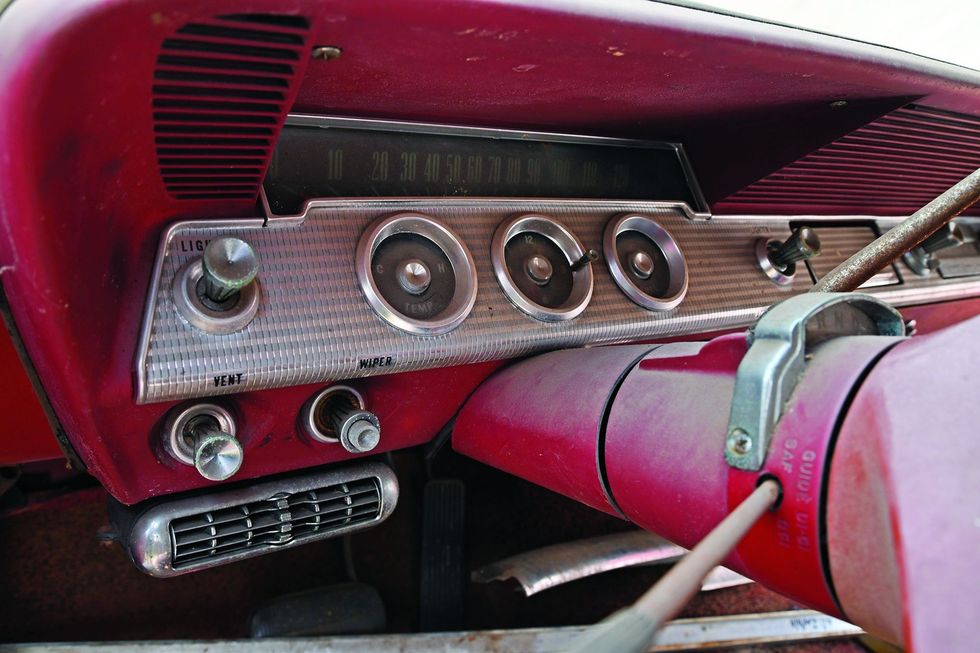 Color closeup of the dash and instrument panel in a 1962 Chevrolet Impala barn find.