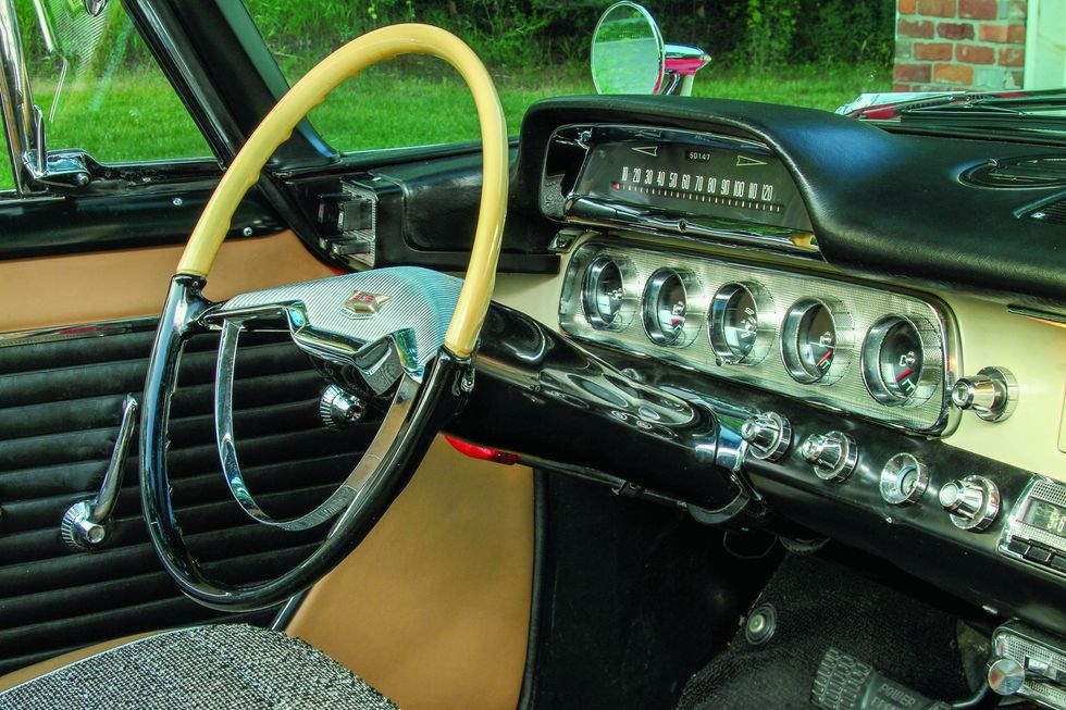 Color closeup of the dash, steering wheel and interior in a 1957 Dodge Custom Royal D-500.