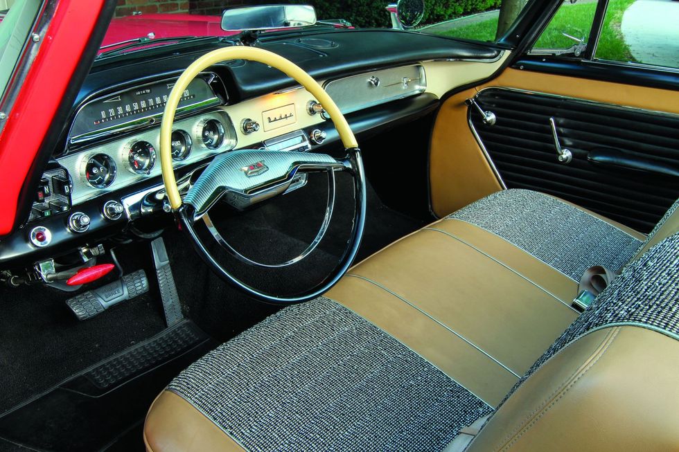 Color closeup of the dash, steering wheel and interior in a 1957 Dodge Custom Royal D-500.