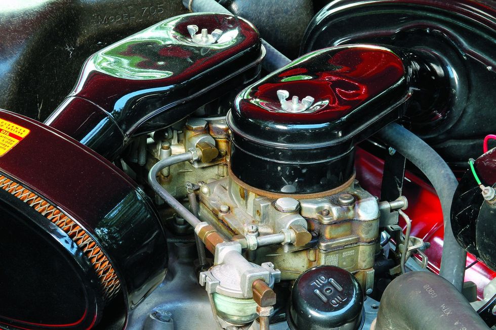 Color closeup of the engine bay and carburetor in a 1957 Dodge Custom Royal D-500.