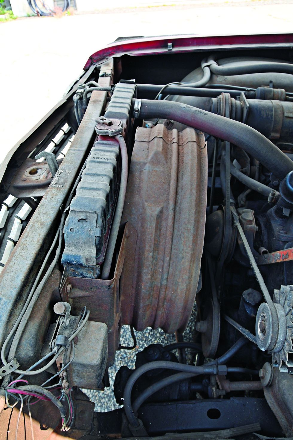 Color closeup of the engine bay in a 1962 Chevrolet Impala barn find.