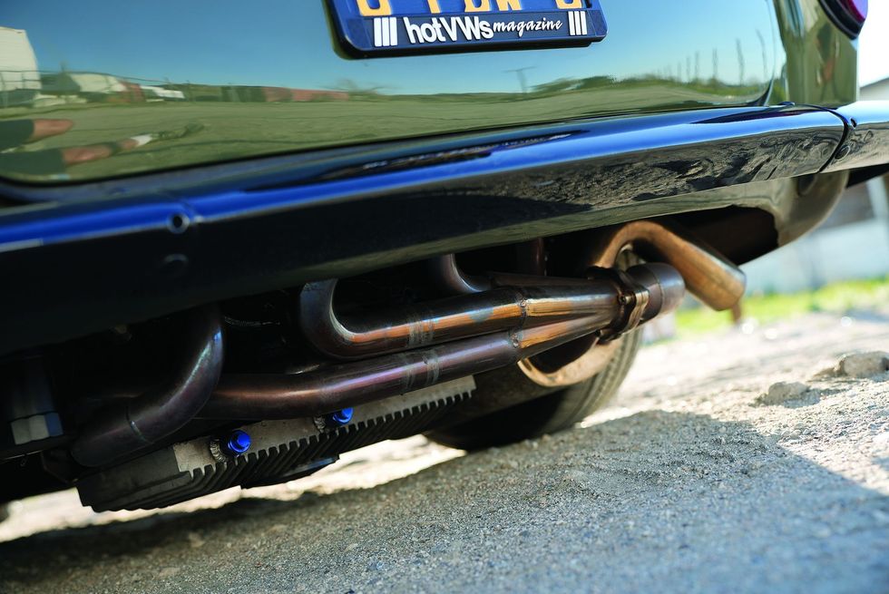 Color closeup of the exhaust area underneath on the bottom of a customized 1965 Volkswagen Karmann Ghia.