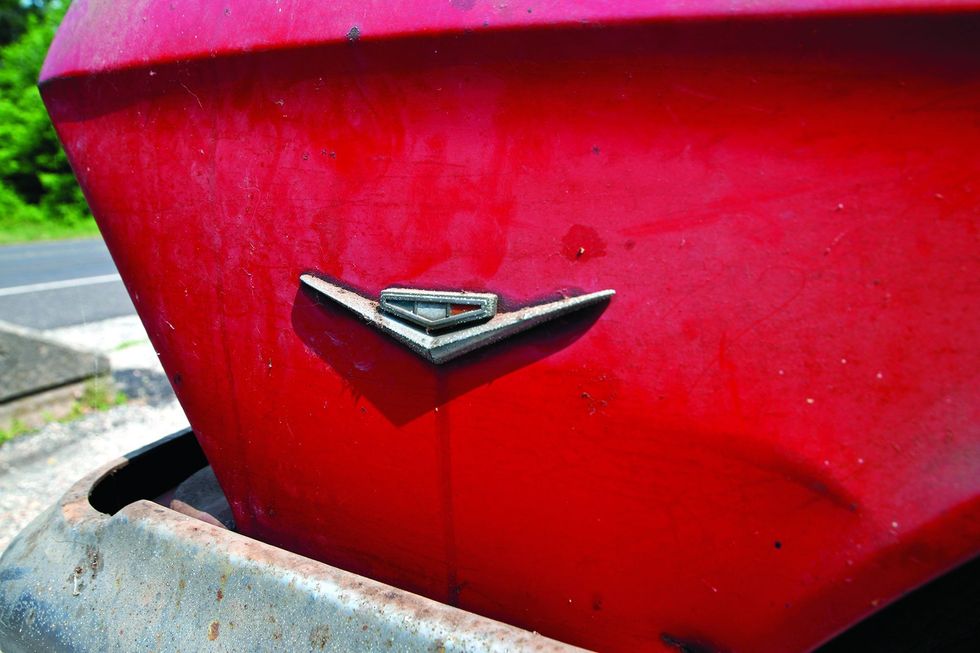 Color closeup of the fender emblem on a 1962 Chevrolet Impala barn find.