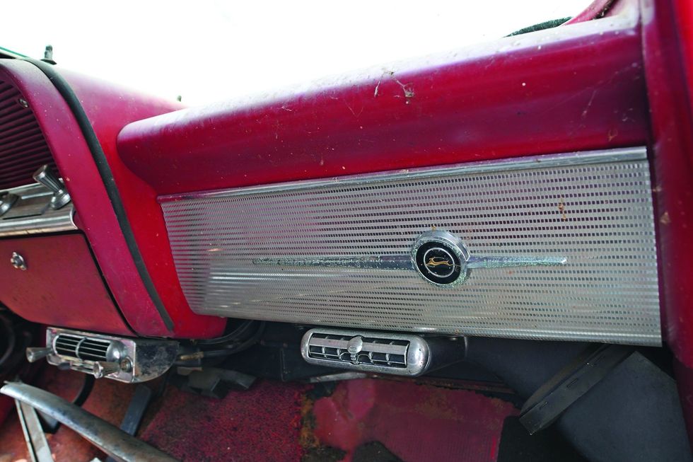 Color closeup of the glove box area in a 1962 Chevrolet Impala barn find.