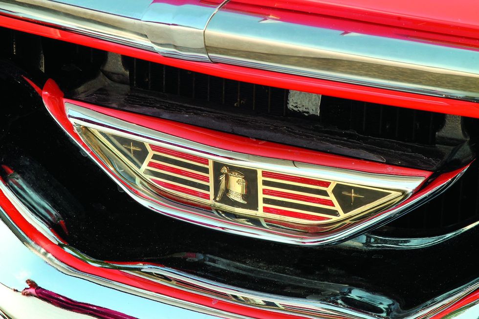 Color closeup of the grille emblem on a 1957 Dodge Custom Royal D-500.