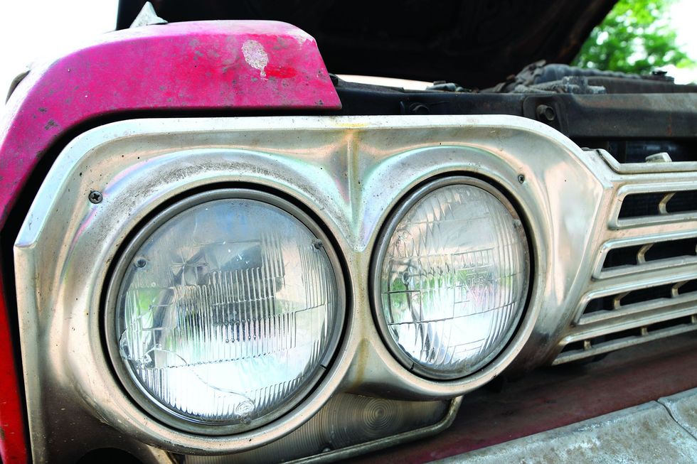 Color closeup of the head lamps on a 1962 Chevrolet Impala barn find.