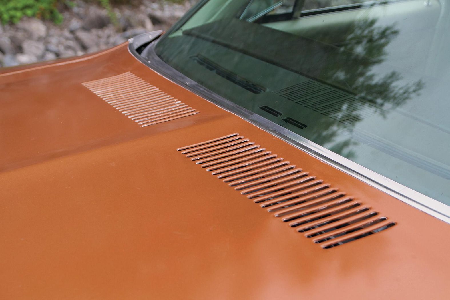 Color closeup of the hood vents and windshield base on a 1972 Pontiac Le Mans.