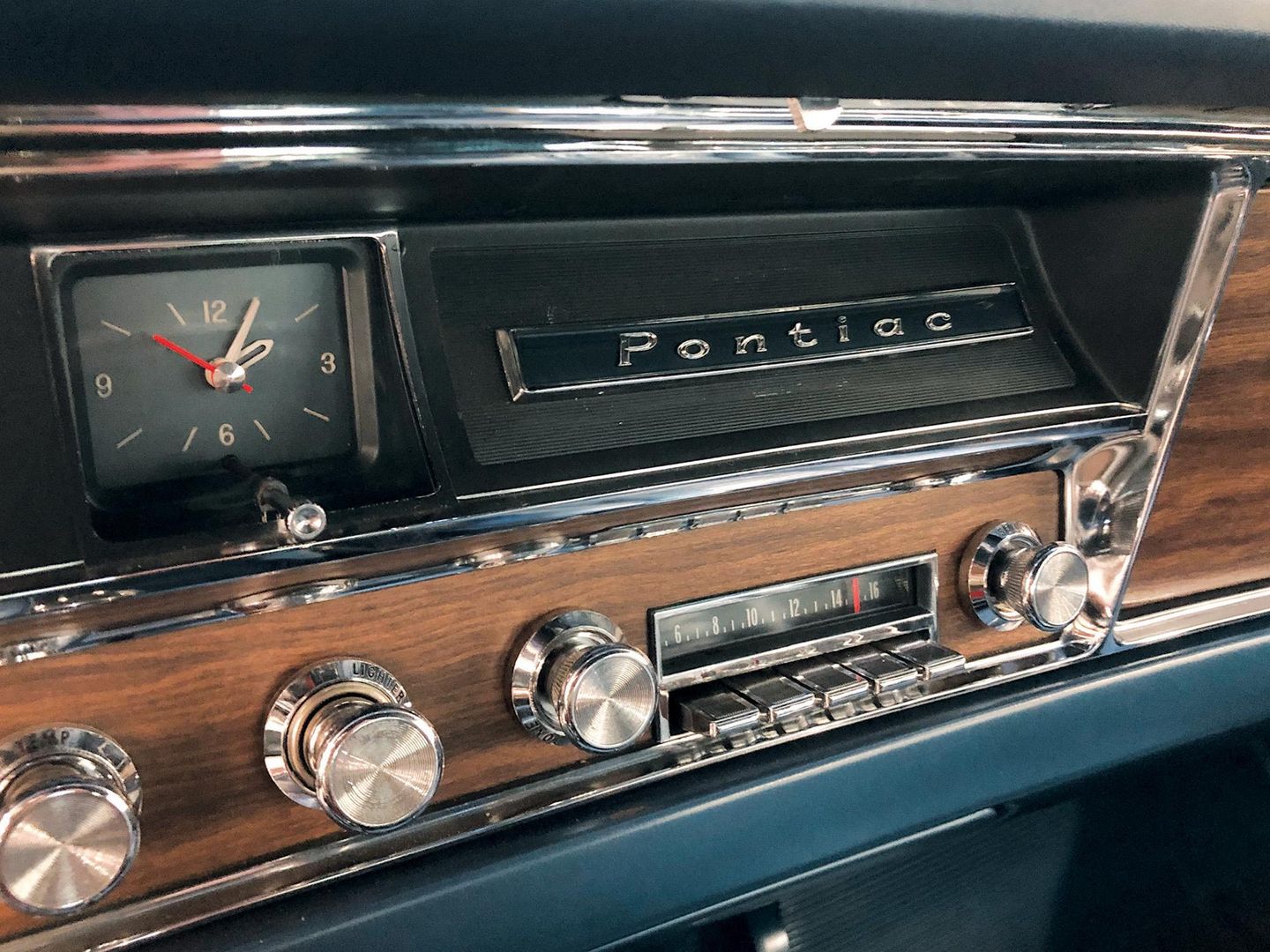 Color closeup of the radio, stereo, knobs and more inside of a 1967 Pontiac Catalina 2+2.