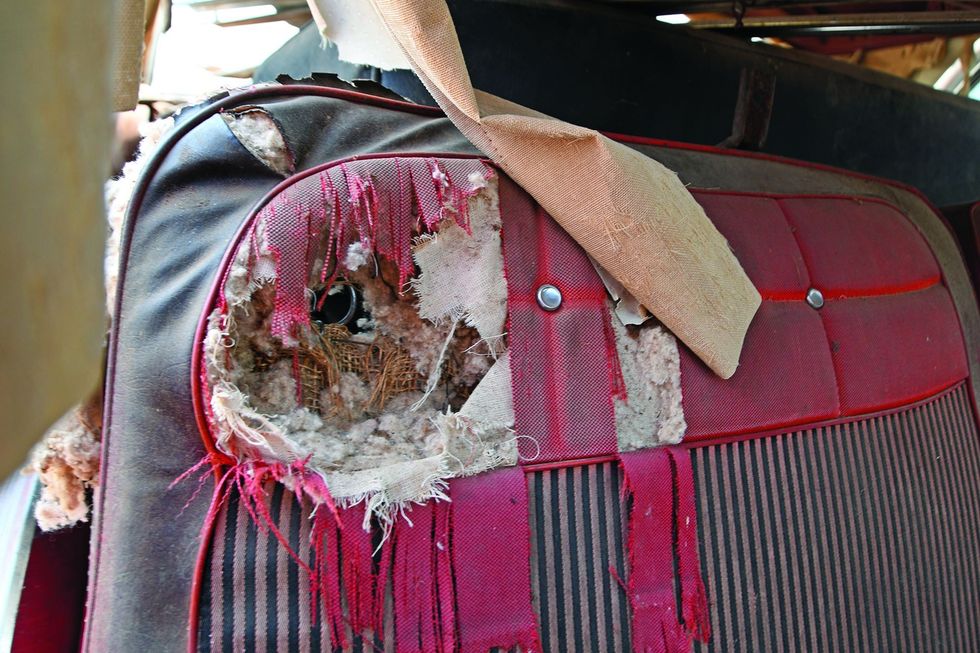 Color closeup of the seat interior ripped in a 1962 Chevrolet Impala barn find.
