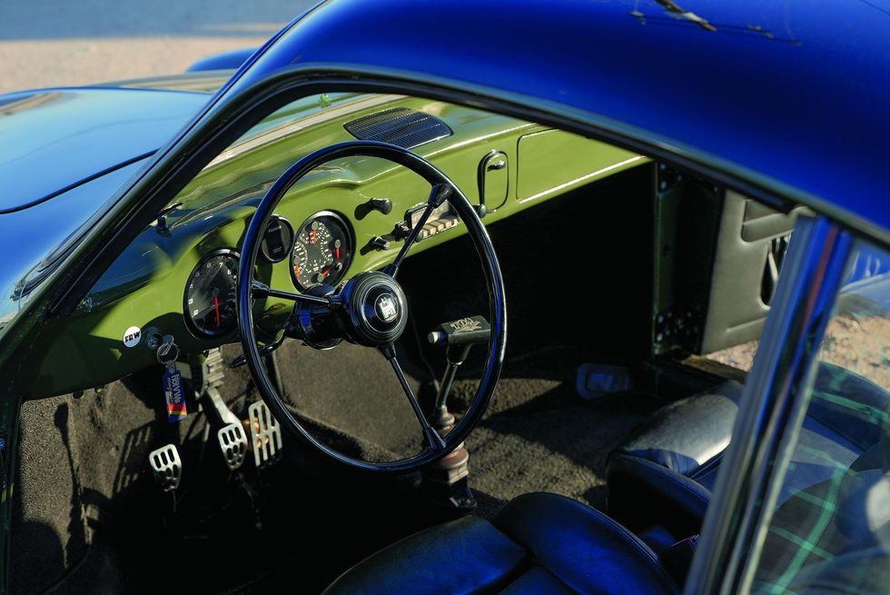 Color closeup of the steering wheel, dash and instrument panel area in a customized 1965 Volkswagen Karmann Ghia.