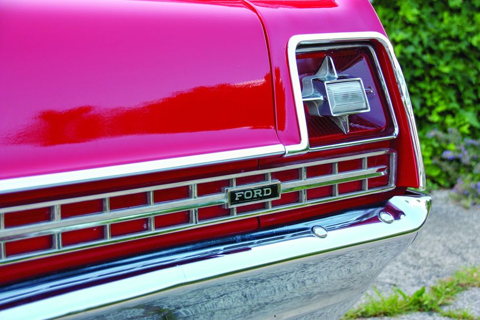 Color closeup of the tail lamp, rear trim and "Ford" emblem on a 1969 Ford XL convertible.