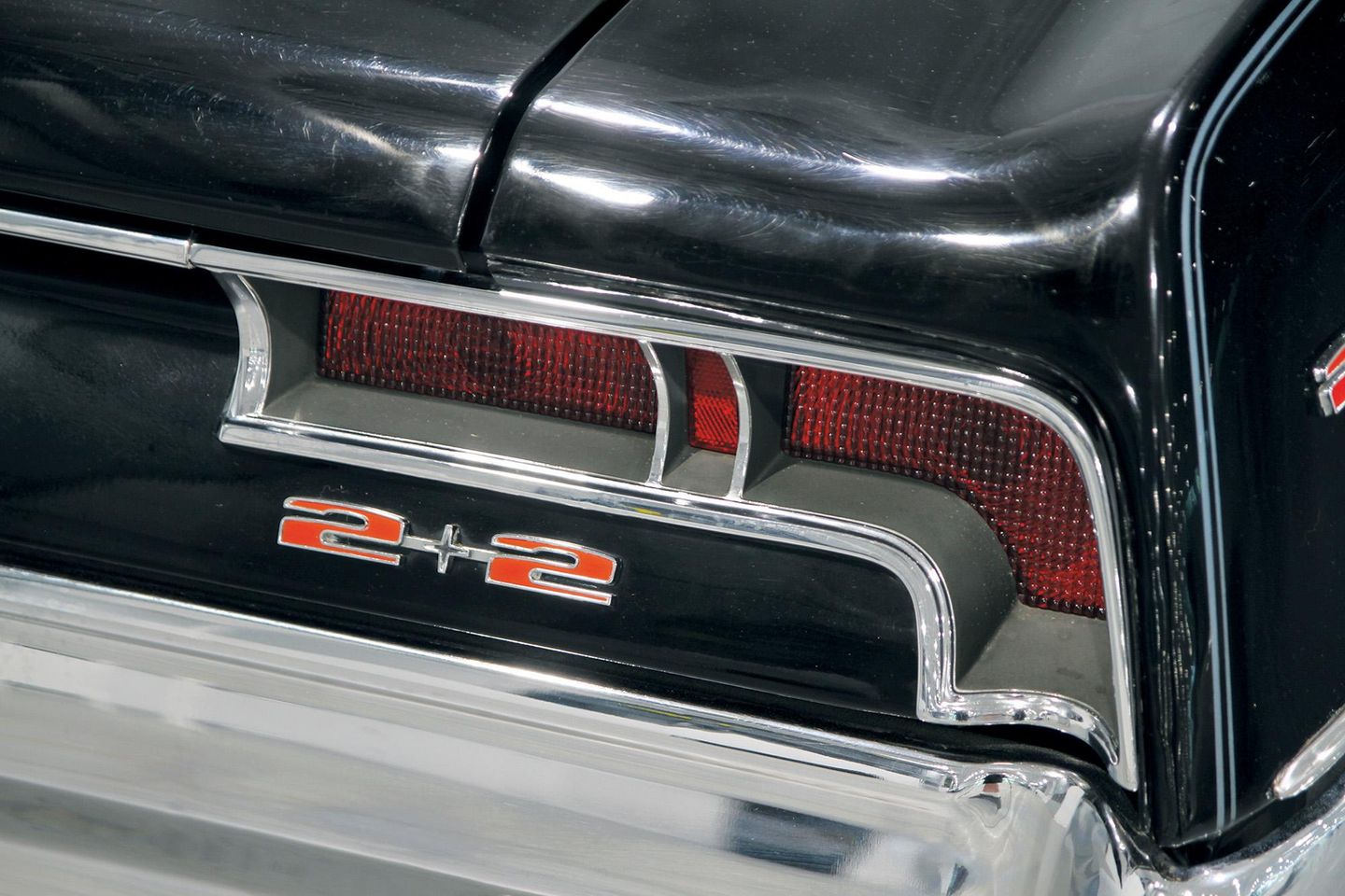 Color closeup of the tail lamps and rear 2+2 badging on the tail panel of a 1967 Pontiac Catalina 2+2.
